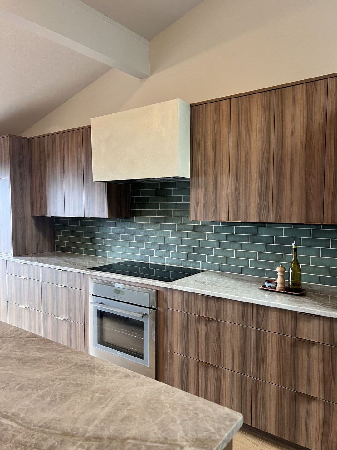Modern bathroom with green tile and plaster half-wall