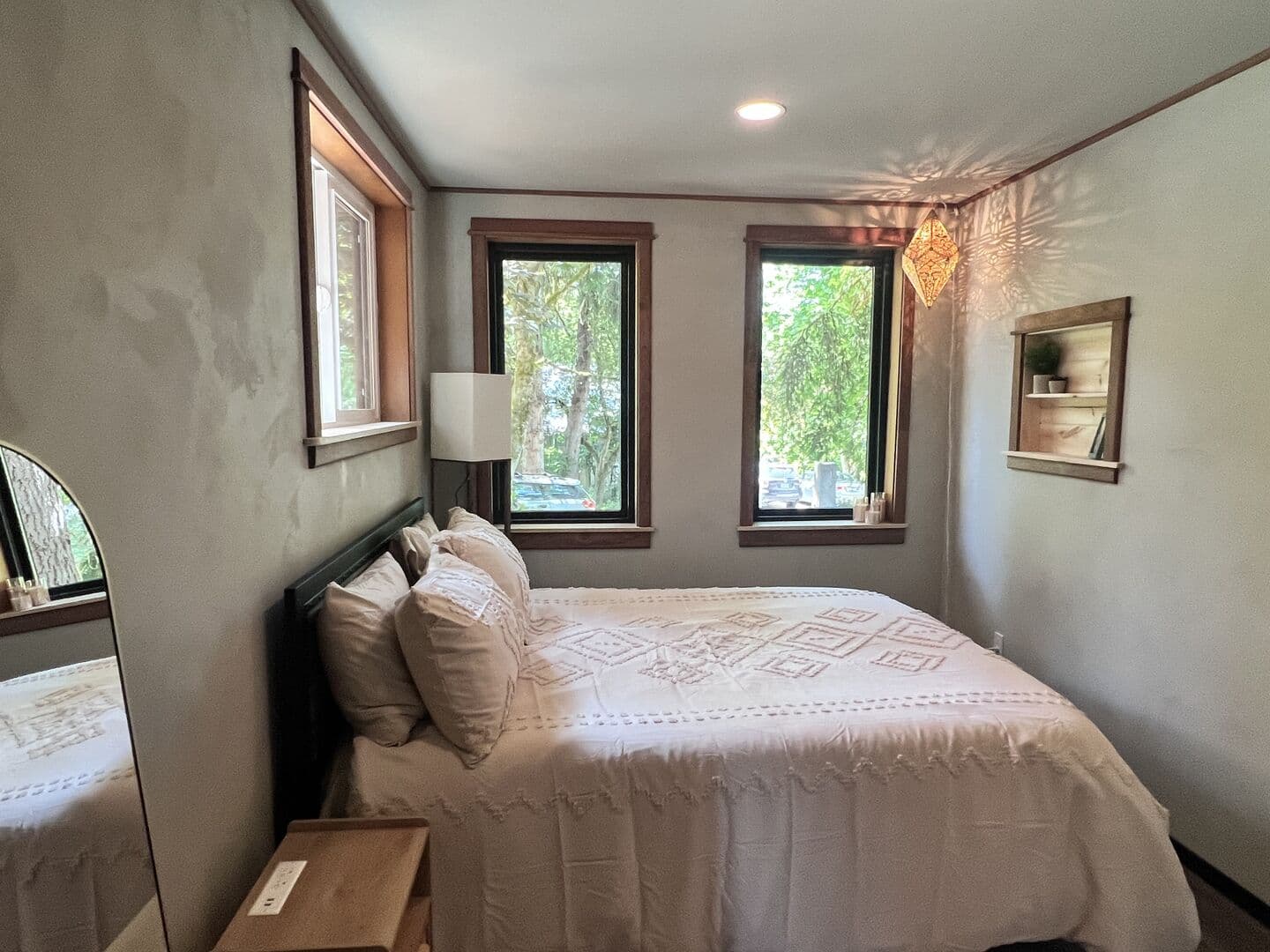 Cozy bedroom with sage plaster walls and natural light
