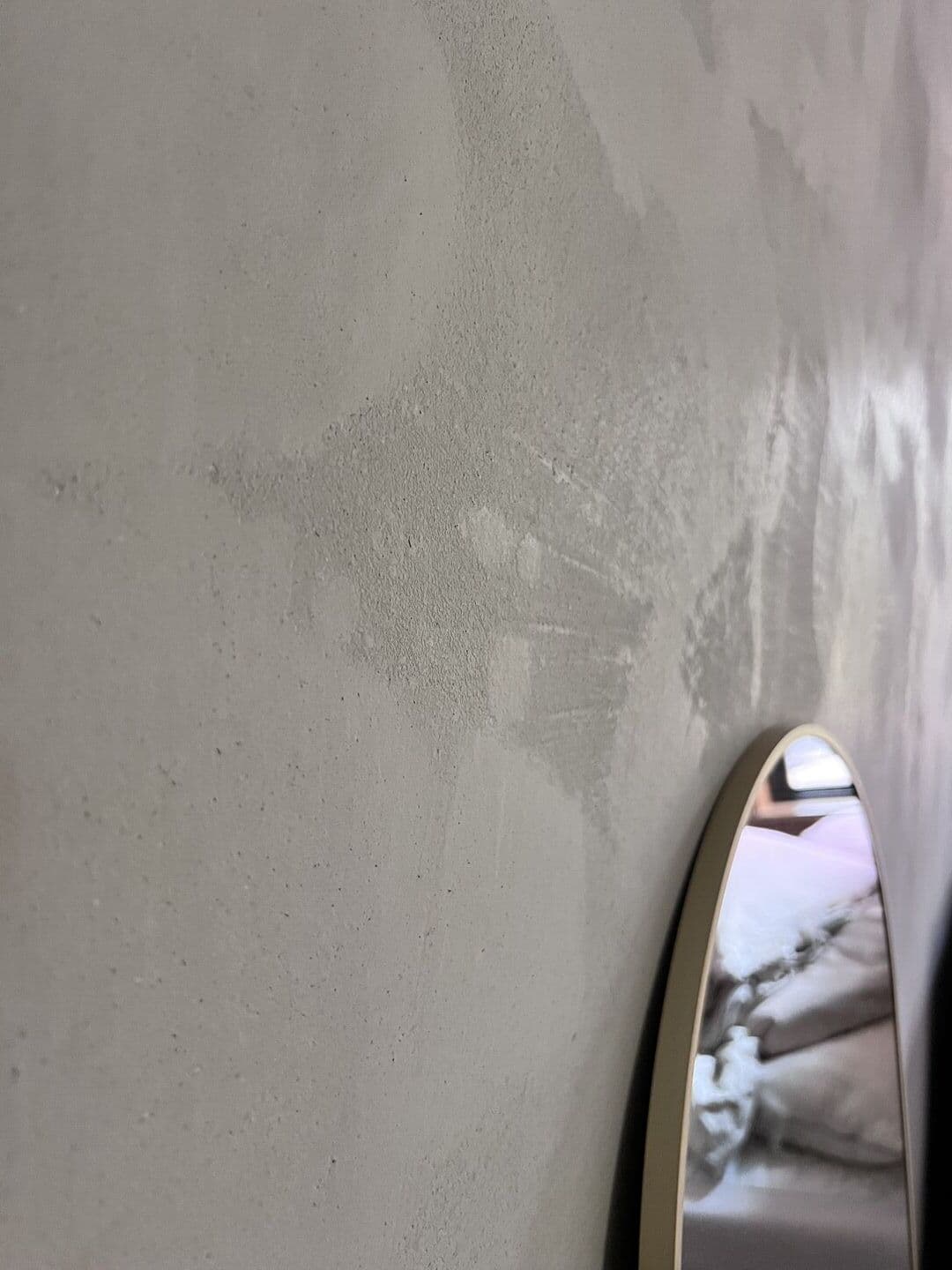 Close-up of polished plaster wall texture with mirror